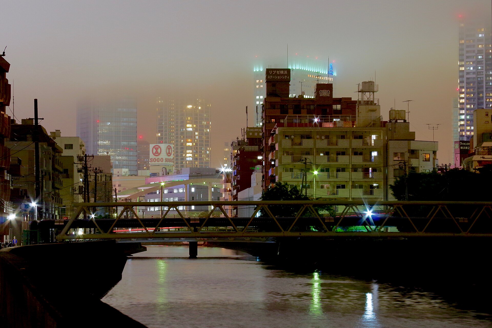 Yokohama at night. Somewhere in that fog, Ado is louder than your thoughts.